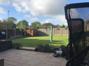 back garden with large lawn and summerhouse