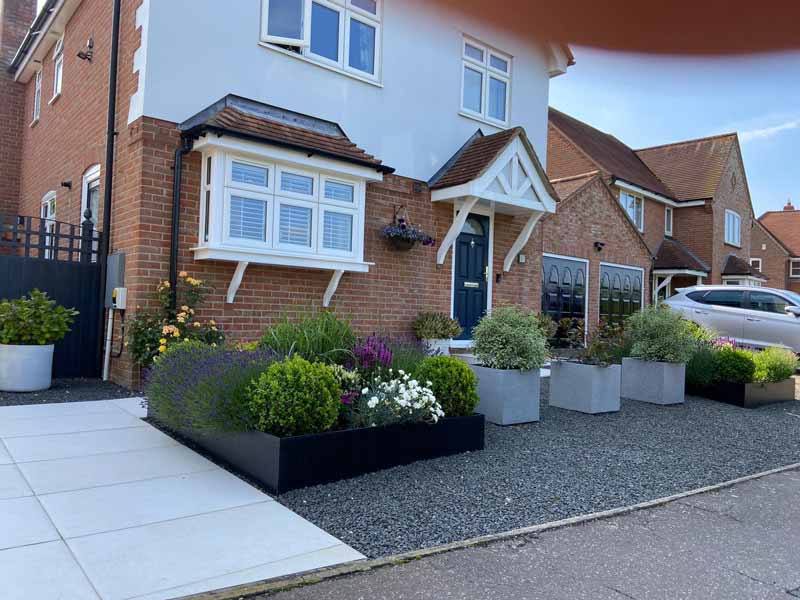 adding colourful containers to a well landscaped front garden adds value to a property